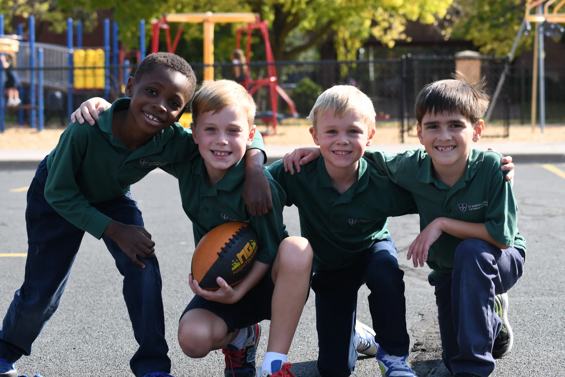 group of 4 students playing basketball